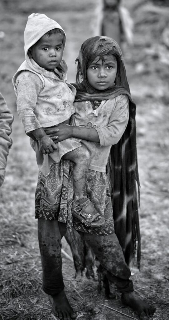 Two young children in rural Sindh, Pakistan, highlighting hardship and resilience.